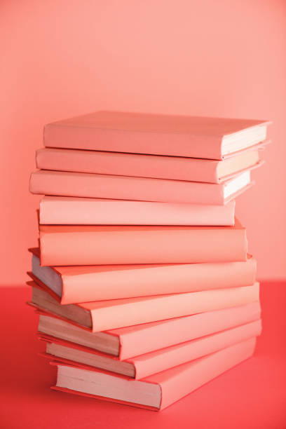 istock stack of books on living coral background 1151417884