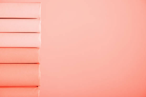 istock stack of books on living coral background with copy space 1151417929