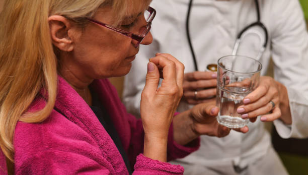 istock Woman taking a pill with water 1151419867