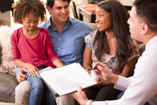 istock Multi-ethnic couple meets with financial advisor. 1151422091