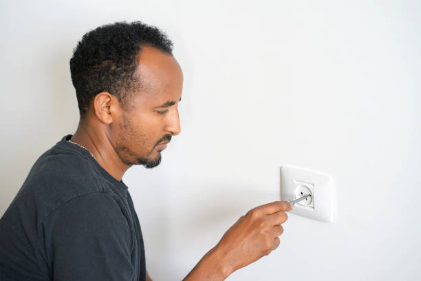 istock An electrician checks the voltage in the wall socket. 1151422766