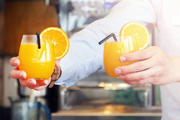 istock Two glasses of orange juice 1151422833
