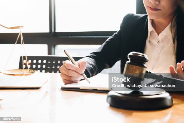 Business Woman And Lawyers Discussing Contract Papers With Brass Scale On Wooden Desk In Office Law Legal Services Advice Justice Concept Stock Photo - Download Image Now