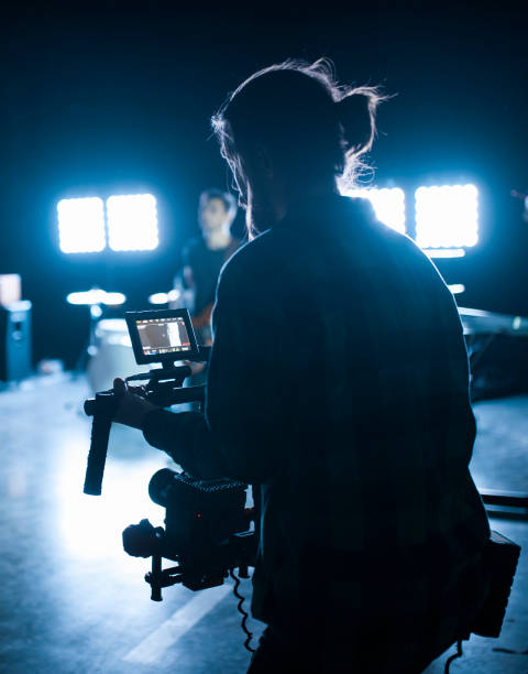 istock Professional videographer holding camera on 3-axis gimbal. Videographer using steadicam. Pro equipment helps to make high quality video without shaking. 1151428369