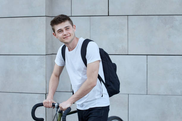 istock Handsome hipster man posing with bicycle in the city. 1151428412