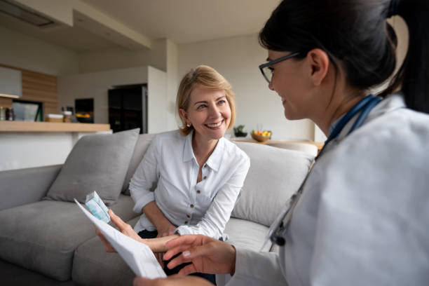 istock Happy doctor talking to a patient at home 1151429367