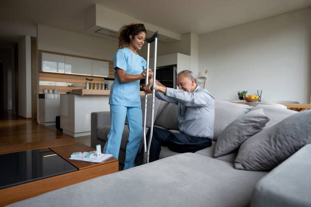 istock Nurse helping a disabled senior man to stand up 1151429452