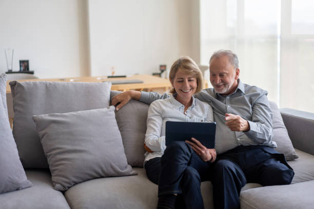 istock Senior couple at home going online on a digital tablet 1151429468