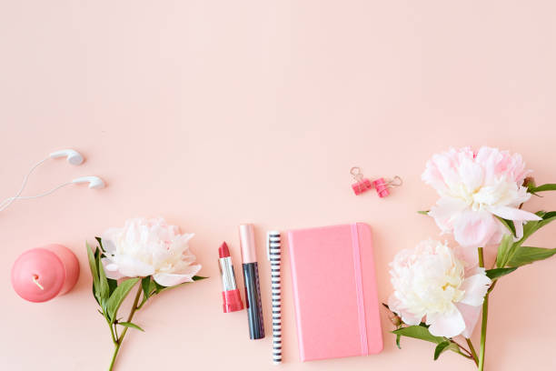 istock Blogger or freelancer workspace with notebook and light pink peonies on a pink background 1151433545