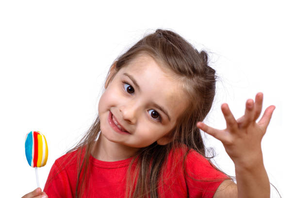 istock Little girl eating a lollipop. 1151433806