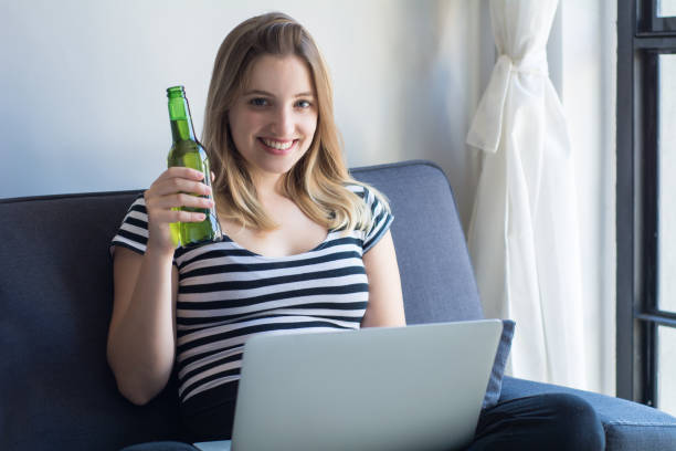 istock Young woman using a laptop computer at home 1151433848