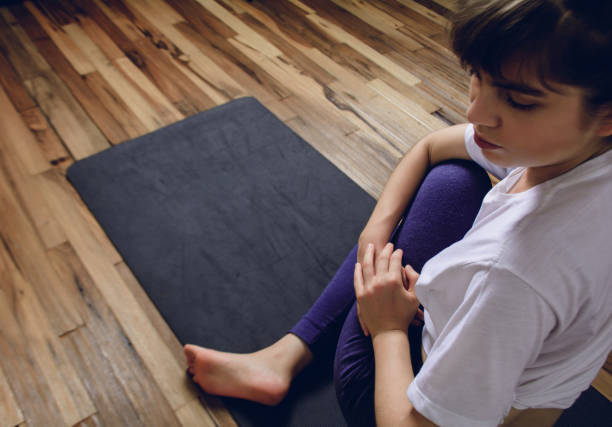 istock Young woman practicing yoga in home. 1151433867