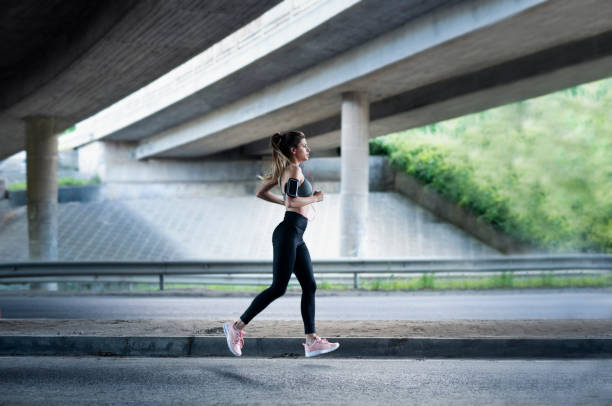 istock Young sport woman running under urban structure. 1151433887