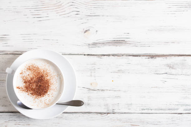 istock cappuccino on rustic white wood board with copyspace 1151434847