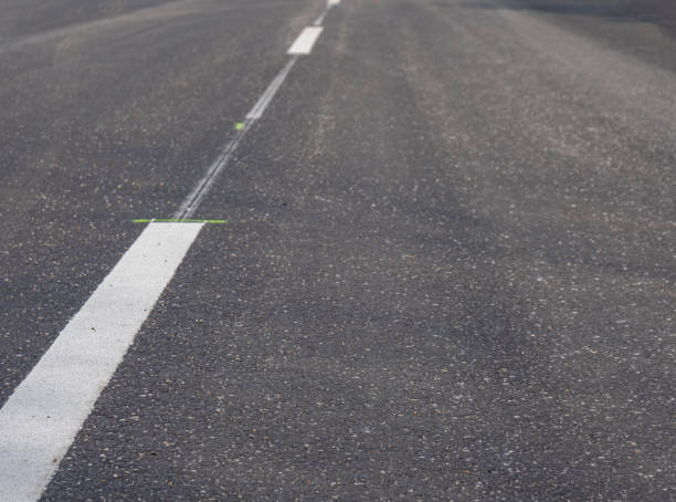 istock white lines with asphalt road 1151435217