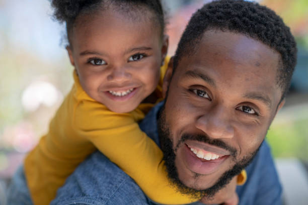 istock A young girl smiling on her dads shoulders 1151435533