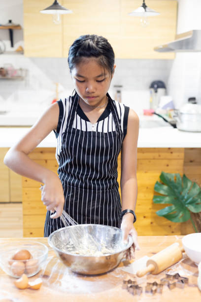 istock Girls mixing dough, making cookies in the kitchen 1151436230