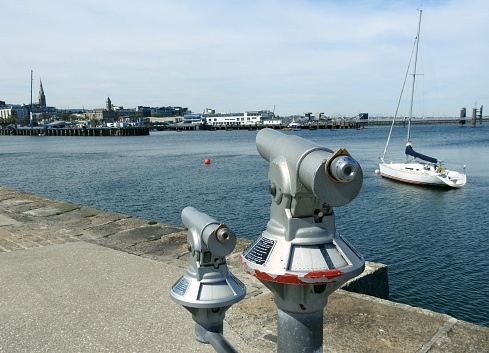 Public viewing telescopes on Dun Laoghaire Pier looking across the harbour towards Dun Laoghaire town.