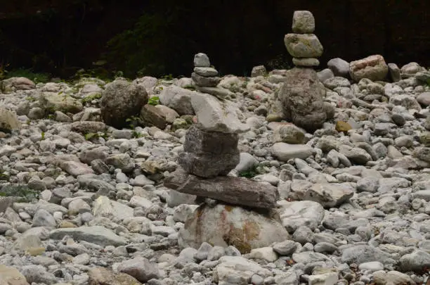 Two stacks of rocks in the woods of Dolomites