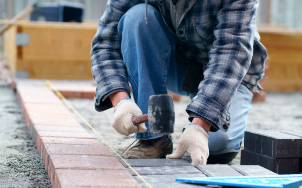 istock Laying gray concrete paving slabs in house and tools 1151449188