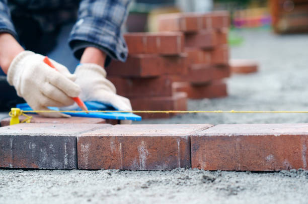 istock Laying gray concrete paving slabs in house and tools 1151449222