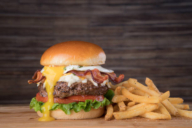 Bacon Egg Burger Fresh bacon egg burger with french fries bacon cheeseburger stock pictures, royalty-free photos & images