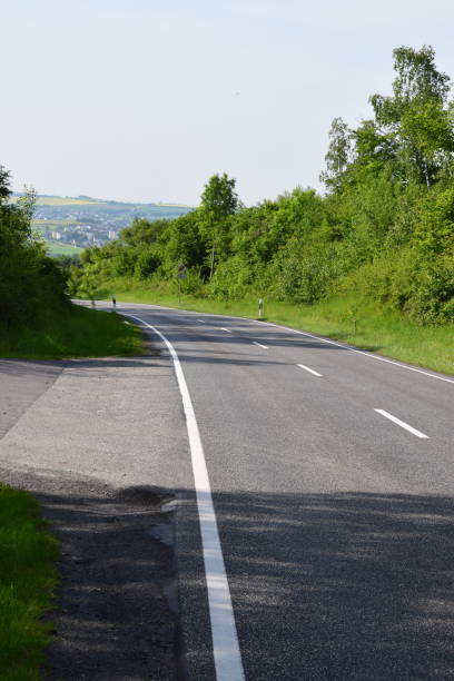 istock country road in spring forest 1151450842