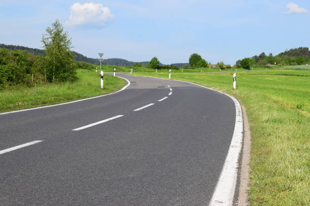 istock deteriorating country road curve 1151452441
