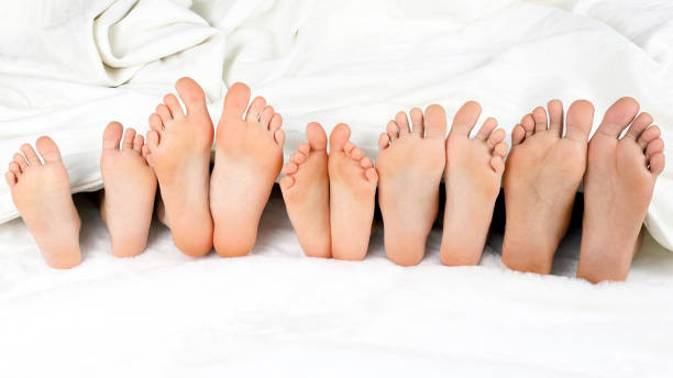 istock children's feet peeking from under the blanket 1151458053