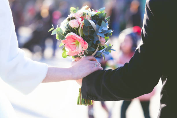 istock the bride and groom holding wedding bouquet 1151458839