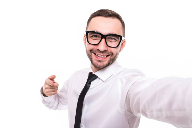 istock Handsome bearded young business man taking selfie pointed on camera isolated over white background. 1151460245