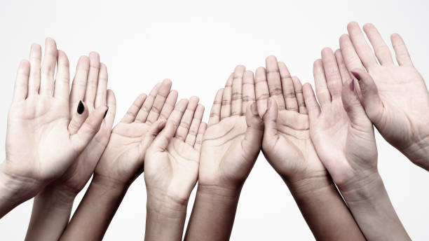 istock Unity and relations in society. many raised hands in a row 1151461530
