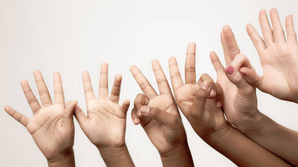 istock many raised children's expressive hands in a row 1151463628