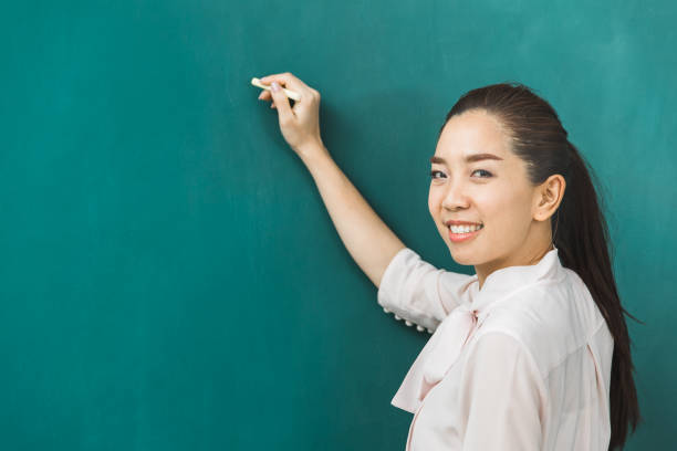 istock Asian teacher chalk on green board. 1151463869