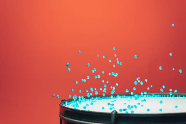 istock Colored balls bounces off drum in shockwave pattern. Beautiful red background. 1151464973