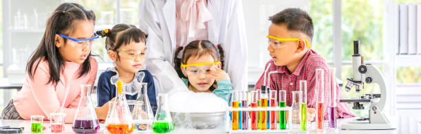 istock Teacher and students in lab, smoke float out. 1151465809