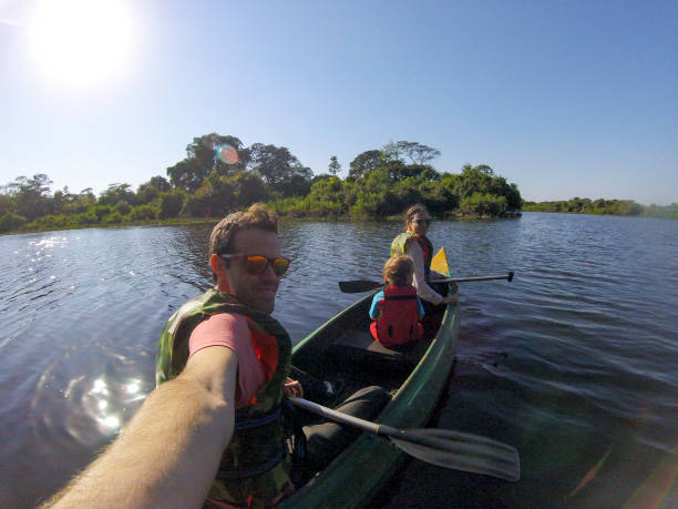 Family canoeing in Pantanal river selfie stock photo