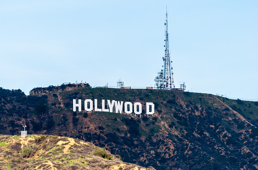 Los Angeles, California, United States of America - January 8, 2017. The Hollywood Sign on Mount Lee in the Hollywood Hills area of Santa Monica Mountains, with telecom tower.