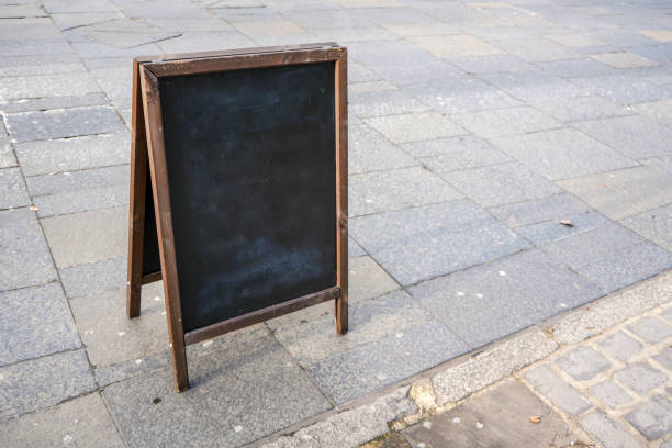 istock Empty blackboard on the street pavement. Mockup to add your own text. 1151473708