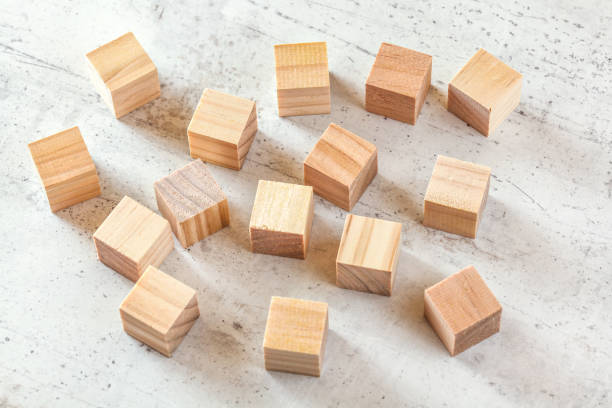 istock 15 wooden playing cubes on white board. 1151474540