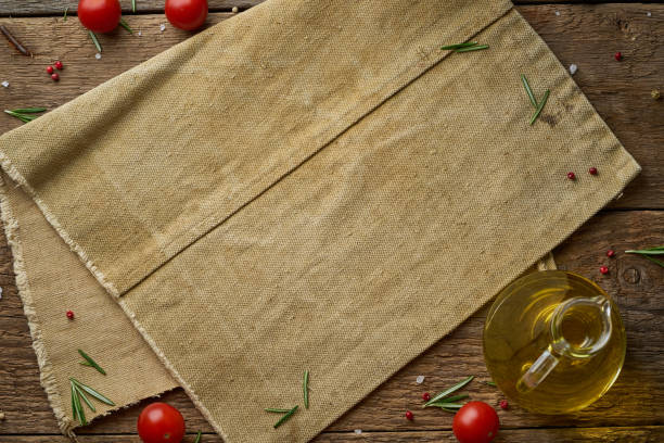 Menu, recipe, mock up, banner. Food seasoning background. Old linen napkin, spices, herbs on old rustic backdrop. Top view, copy space. stock photo