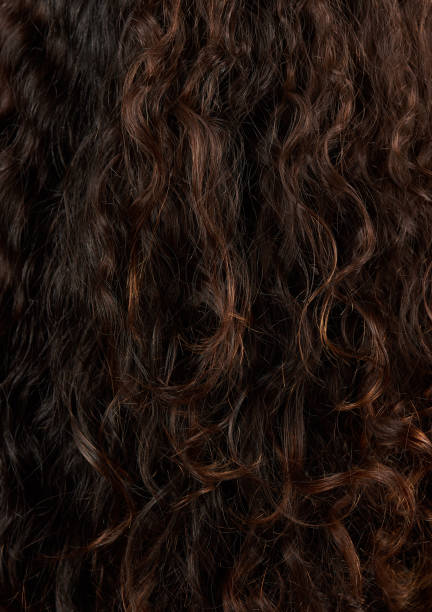 istock Brown curly hair closeup 1151475698
