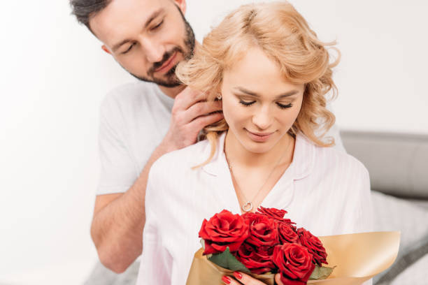 istock Relaxed romantic couple posing with red roses 1151478193