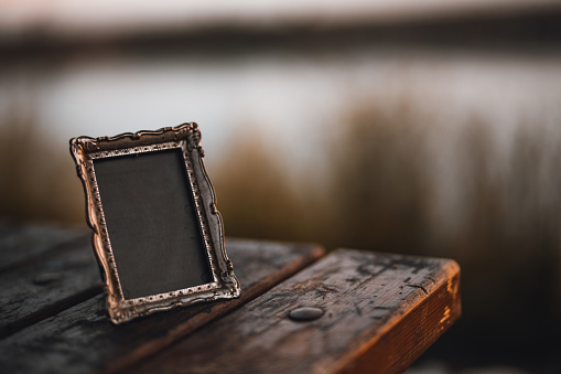Empty photo frame on a wooden table