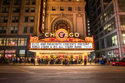 Chicago, Illinois, USA - September 22, 2018:   People and traffic gather by the Chicago Theatre on North State Street in the Loop area of Chicago, Illinois USA.