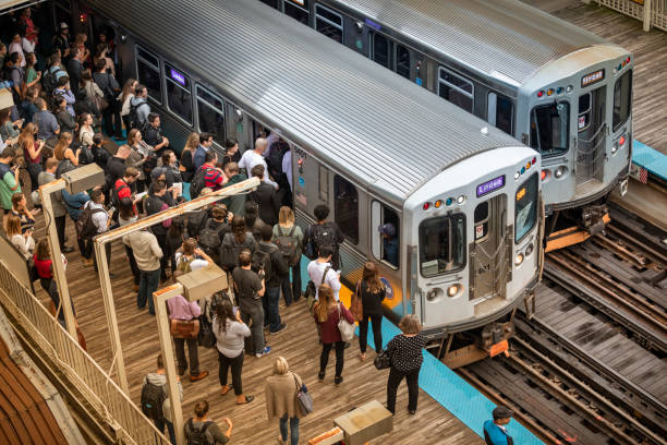 Chicago, Illinois, USA - September 24, 2018:  Commuters wait on the platform for the elevated train on the tracks in the Loop area of downtown Chicago Illinois USA
