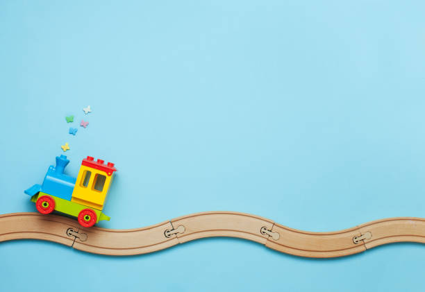 istock Kids train on toy wooden railway on blue background 1151483729
