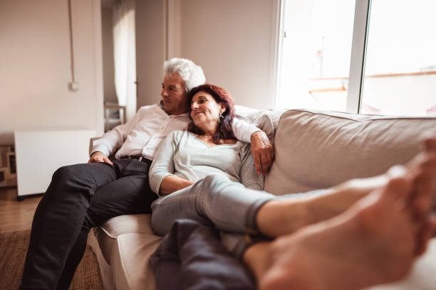 istock mature couple resting on the couch 1151486570
