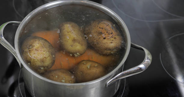 istock Hot boiling pan with vegetables potatoes and carrots. Cooking in kitchen 1151486584