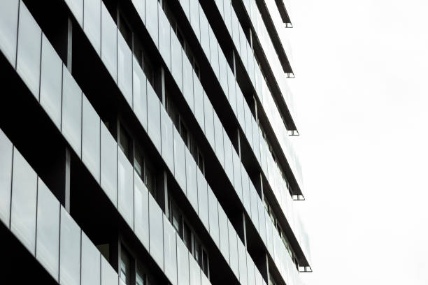 istock Low angle view of modern residential building, white background with copy space 1151487289